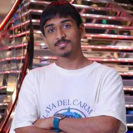 A young brown man with black hair appears wearing a t-shirt in an indoor setting.