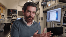 Mohammad Hafezi sits in a laboratory setting, gesturing with his hands while speaking.